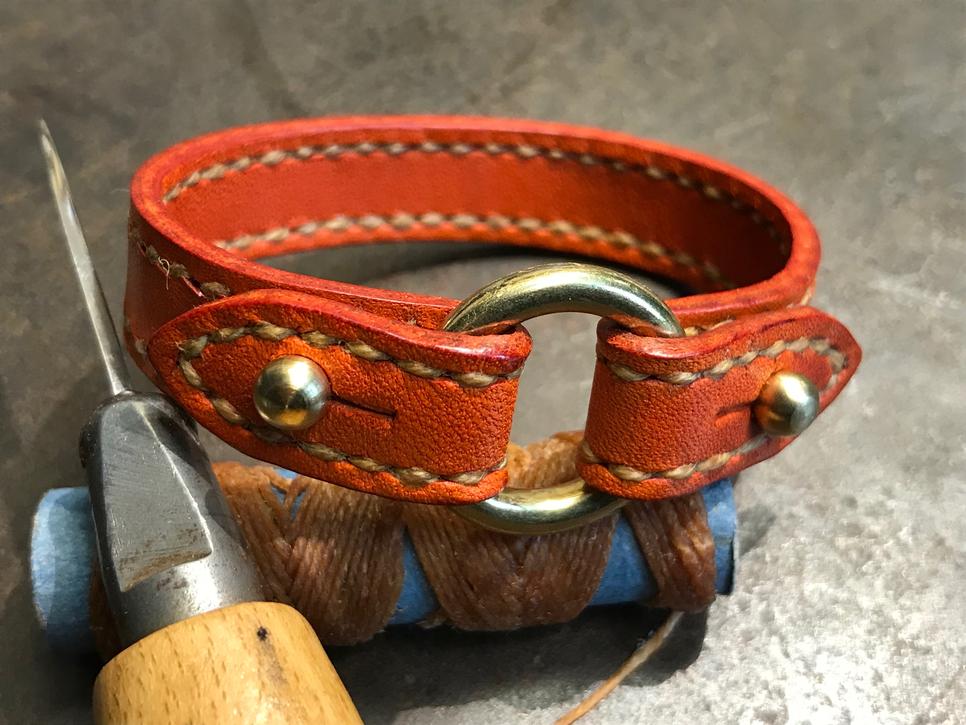 Orange leatherand brass bracelet hand stitched